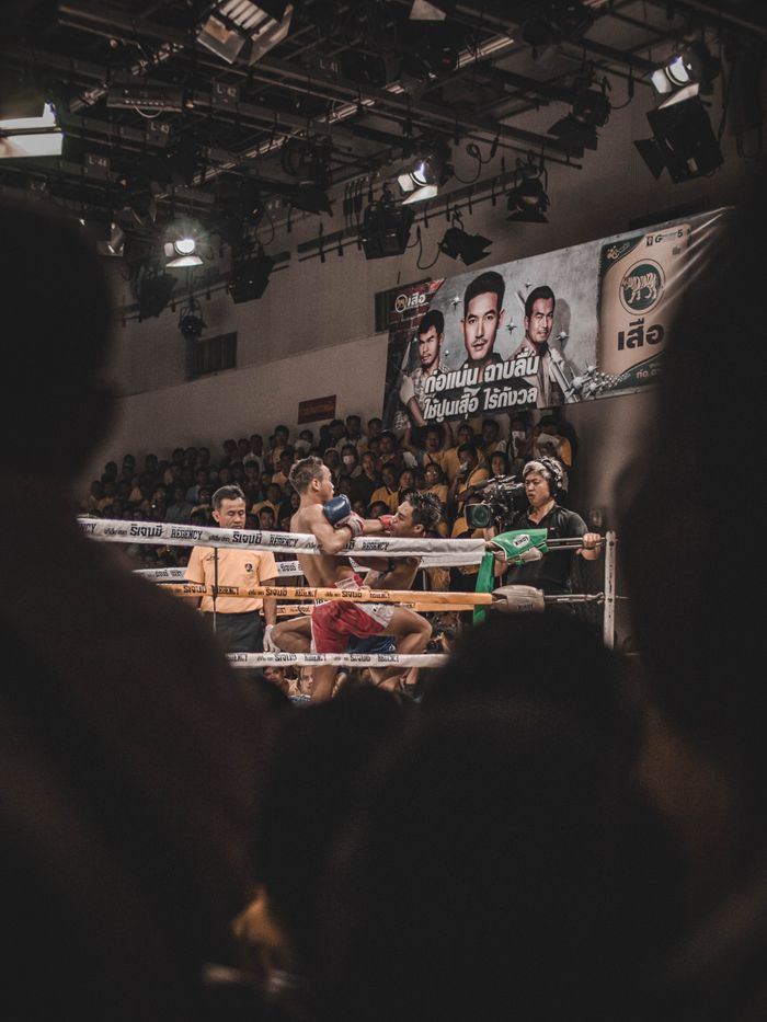 Fierce Muay Thai boxing match captivates audience in Bangkok, Thailand.